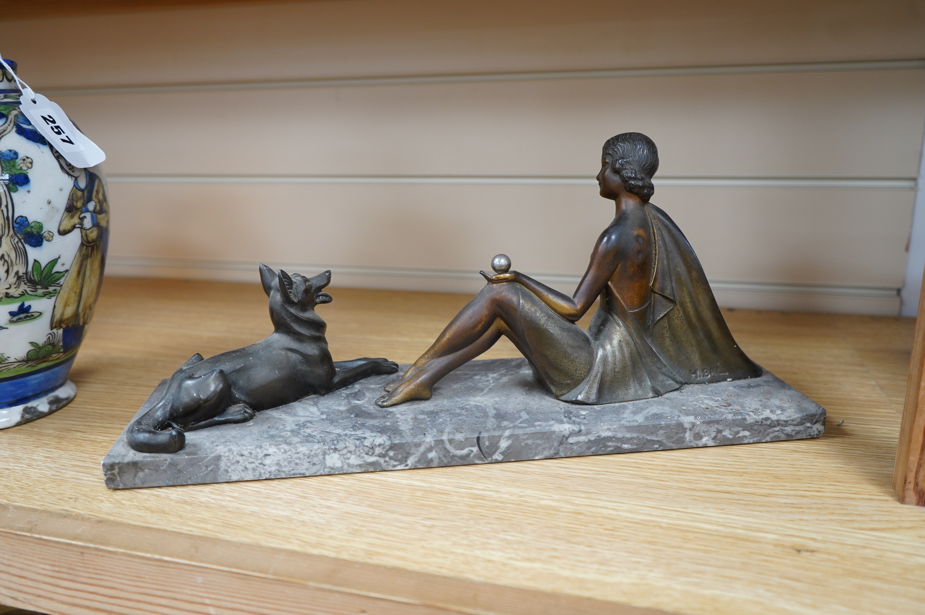 A French Art Deco spelter figure group, woman and dog, on marble base, signed H. BAL, 40cm long. Condition - fair to good